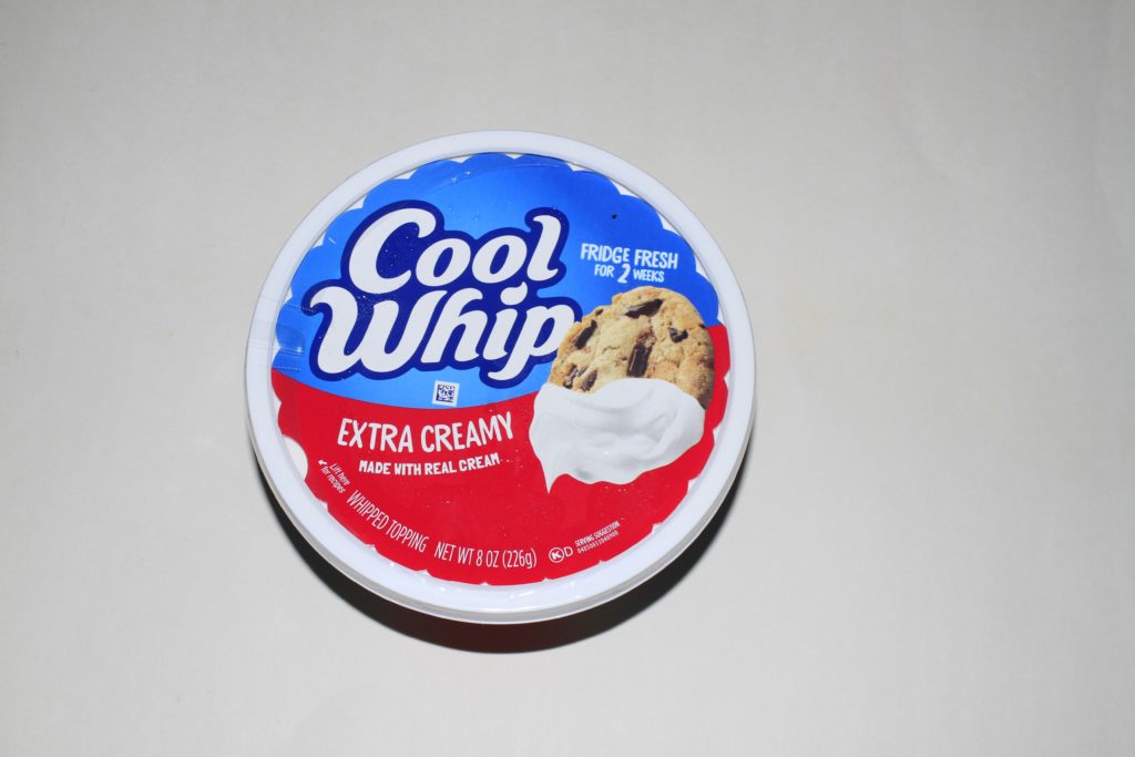 A closeup shot of a cool whip container that's bright and colorful